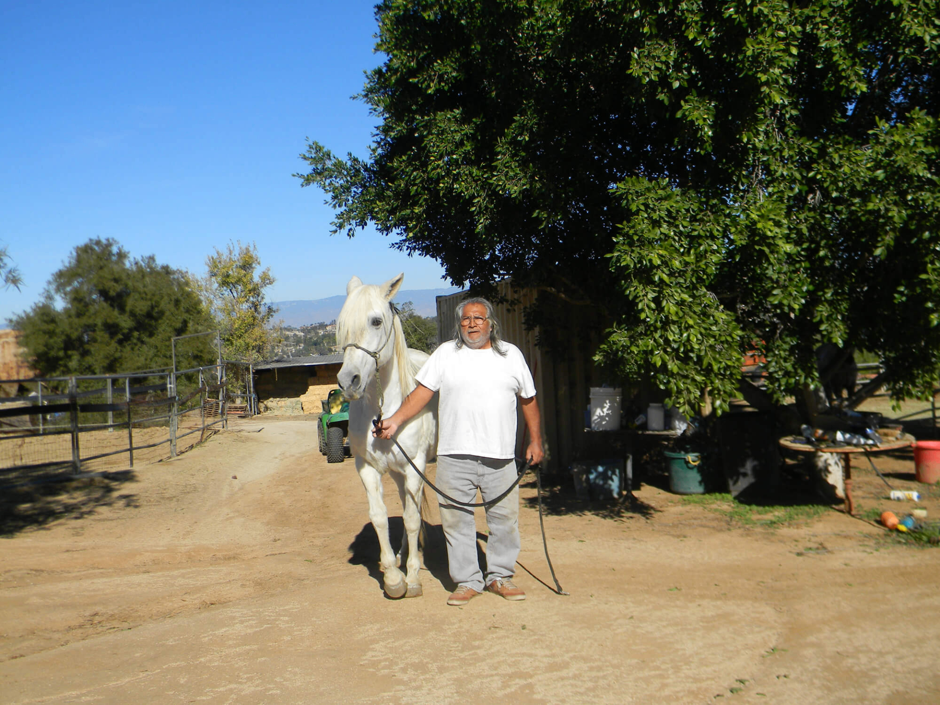 Jake standing with Lady on the ranch road